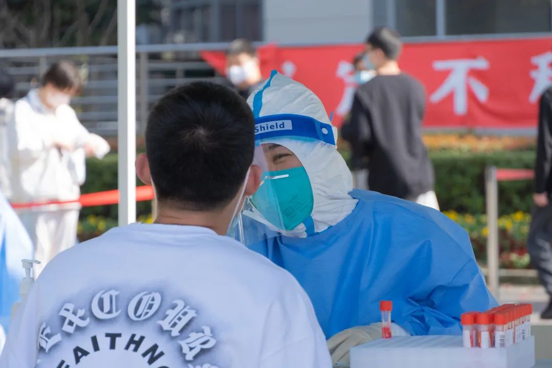 图为学生正在做核酸检测